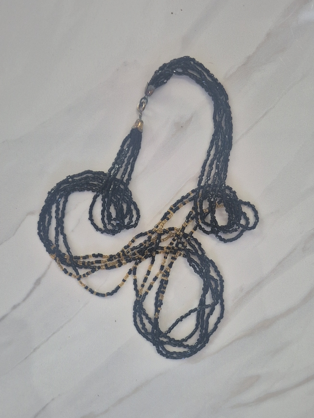Multi-Strand Black and Gold Beaded Necklace.